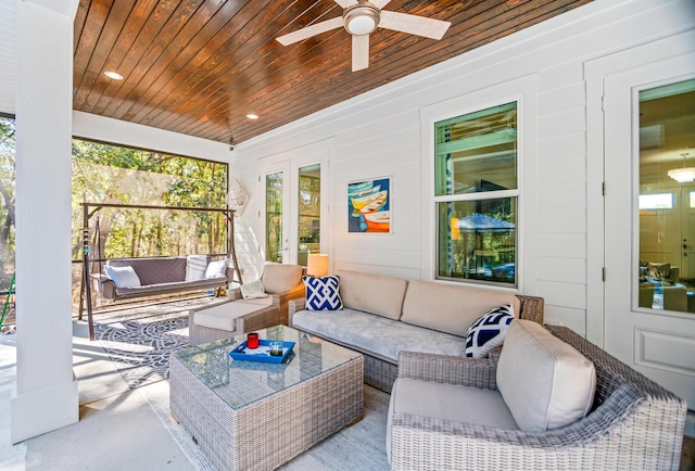 sunroom / solarium featuring wood ceiling and ceiling fan