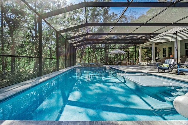 view of pool featuring a patio and glass enclosure