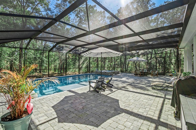 view of pool with an in ground hot tub, a lanai, and a patio