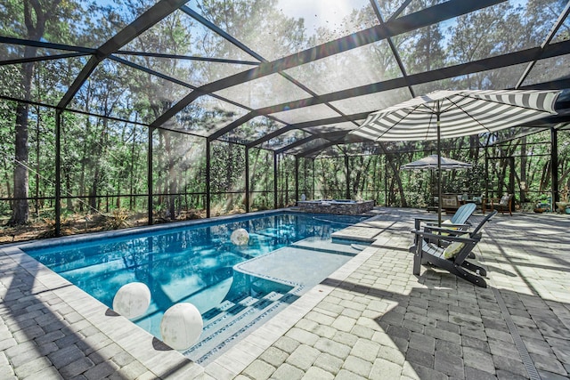 view of pool with a lanai and a patio area