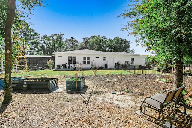 rear view of house featuring a yard