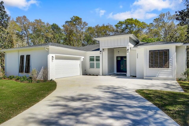 view of front of house with a garage and a front yard