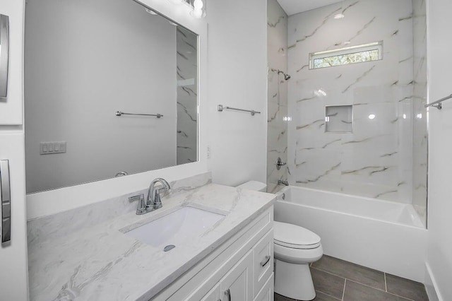 full bathroom featuring vanity, toilet, and tiled shower / bath combo