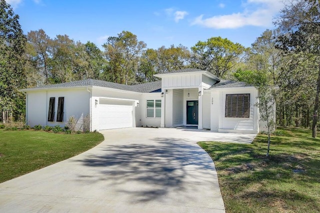 view of front of house with a garage and a front lawn