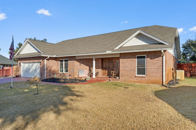 ranch-style house featuring a garage, central AC unit, and a front lawn