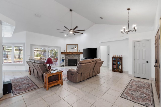 tiled living room featuring high vaulted ceiling and ceiling fan with notable chandelier