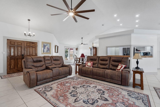 living room with light tile patterned flooring, ceiling fan with notable chandelier, and high vaulted ceiling