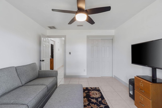 living room with ceiling fan and light tile patterned floors