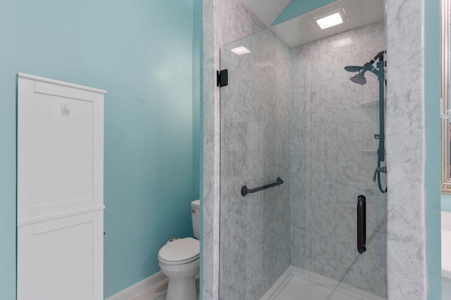 bathroom featuring an enclosed shower and toilet