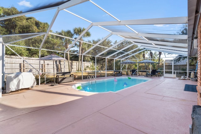 view of pool featuring grilling area, a lanai, and a patio area