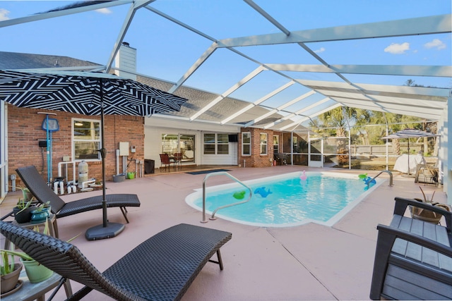 view of pool featuring a patio and glass enclosure