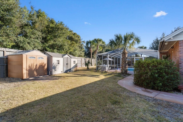 view of yard with a shed, a lanai, and a swimming pool