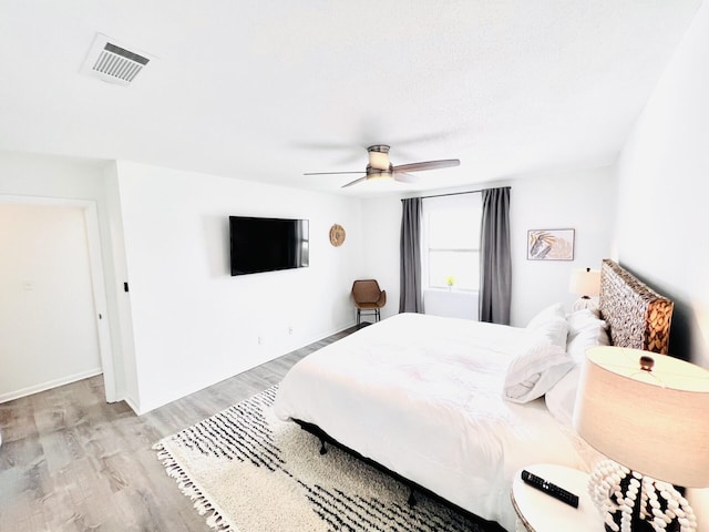 bedroom featuring ceiling fan and light hardwood / wood-style flooring