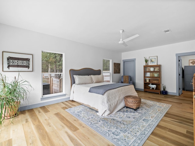 bedroom with wood-type flooring, ceiling fan, and a closet