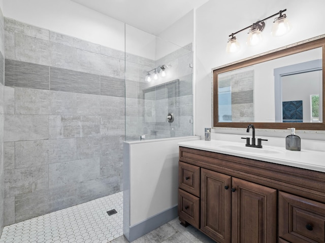 bathroom featuring vanity and tiled shower