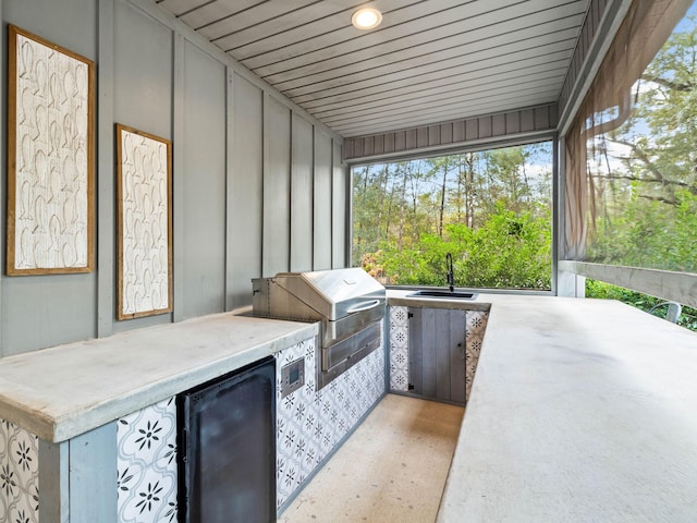 view of patio with a grill, area for grilling, and sink