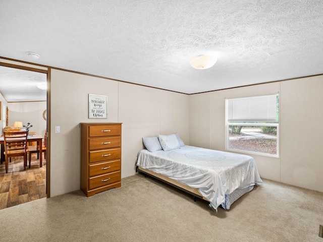 carpeted bedroom with a textured ceiling