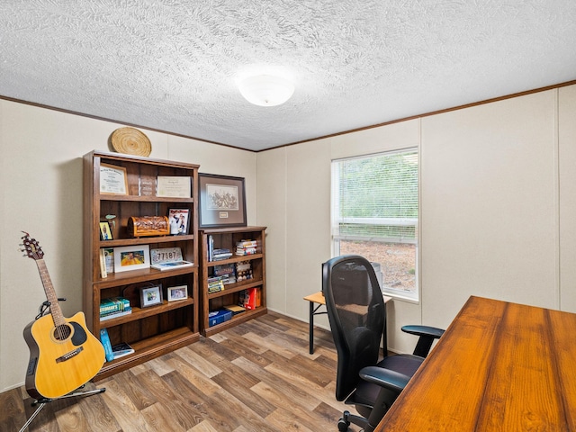 home office with wood-type flooring, a textured ceiling, and crown molding