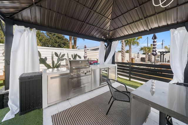 view of patio featuring a gazebo, an outdoor kitchen, and area for grilling