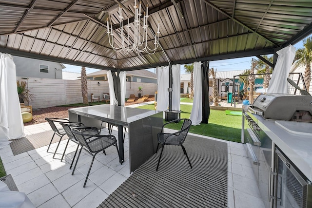 view of patio with area for grilling, a gazebo, and a playground