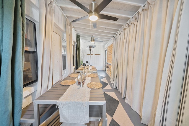 sunroom / solarium featuring beam ceiling