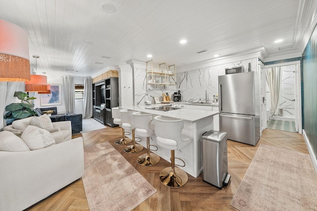 kitchen with crown molding, stainless steel fridge, light parquet floors, a kitchen breakfast bar, and white cabinets