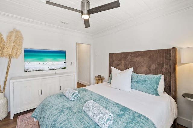 bedroom featuring dark wood-type flooring, ornamental molding, and ceiling fan