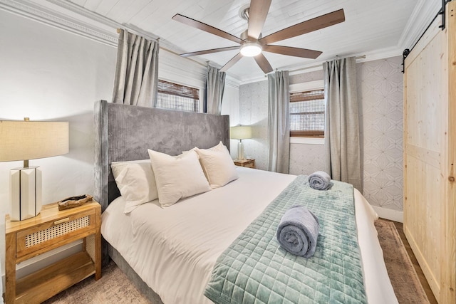 bedroom with crown molding, a barn door, and ceiling fan