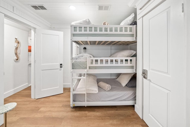 bedroom featuring hardwood / wood-style flooring and ornamental molding