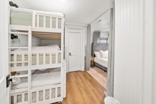 bedroom with wood ceiling and hardwood / wood-style flooring