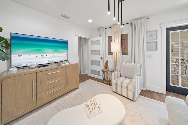 living room with light hardwood / wood-style floors