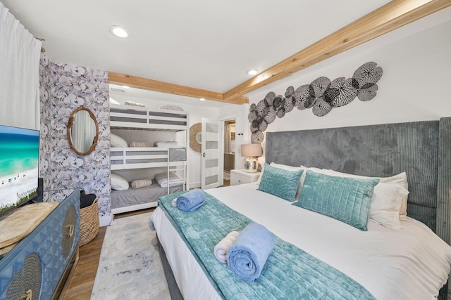 bedroom featuring beamed ceiling and dark hardwood / wood-style flooring