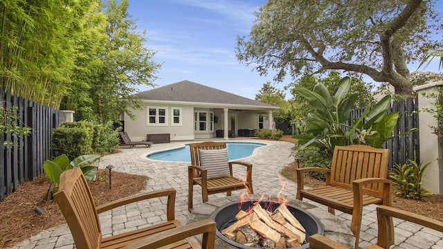 view of swimming pool with a patio and an outdoor fire pit