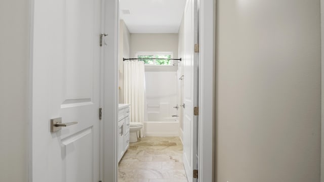 bathroom with shower / bath combination with curtain and toilet