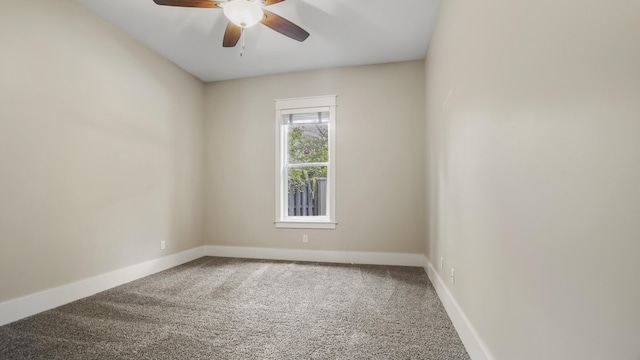 unfurnished room with ceiling fan and carpet