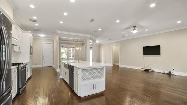 kitchen featuring sink, an island with sink, white cabinets, and appliances with stainless steel finishes