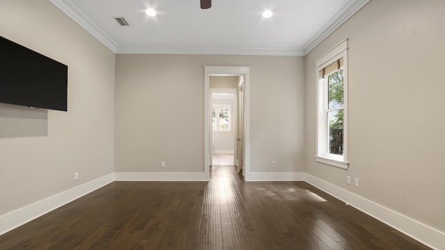 unfurnished living room featuring dark wood-type flooring, ornamental molding, and ceiling fan