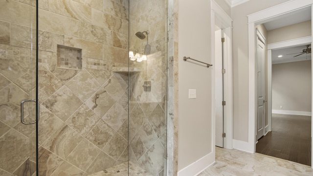 bathroom featuring a shower with shower door and ceiling fan