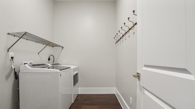 clothes washing area with dark wood-type flooring and independent washer and dryer