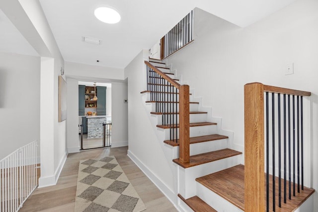 staircase featuring wood-type flooring