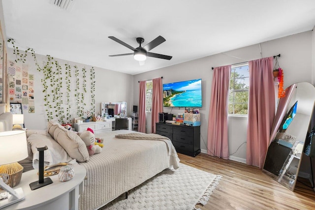 bedroom with light hardwood / wood-style flooring and ceiling fan