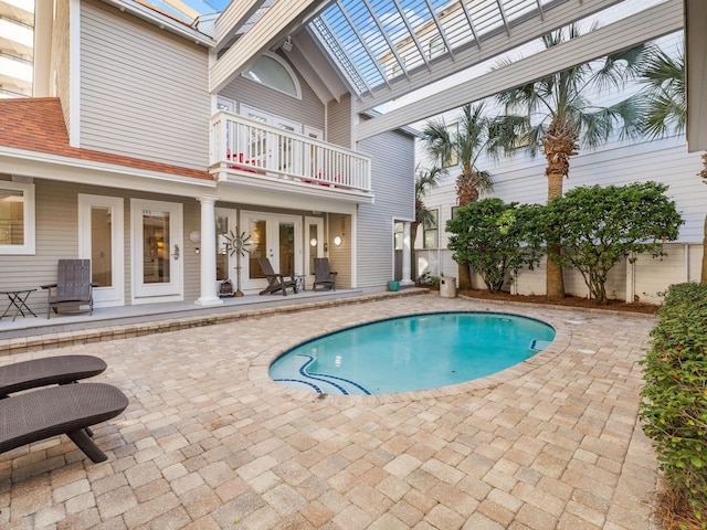 view of swimming pool with french doors, a pergola, and a patio area