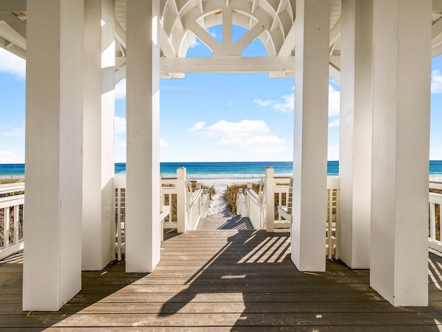 deck featuring a water view and a view of the beach