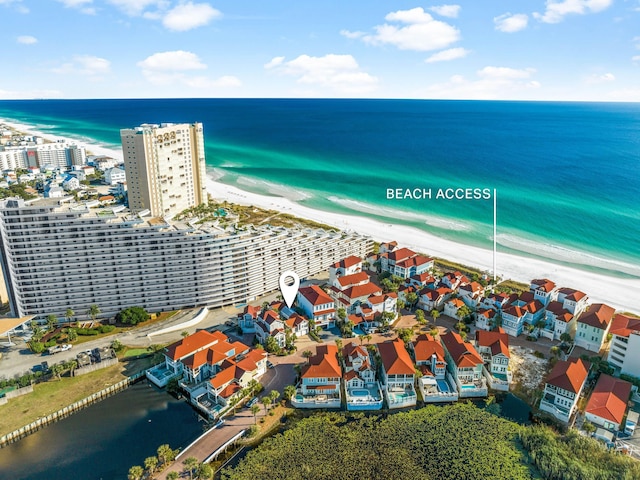 birds eye view of property featuring a water view and a view of the beach