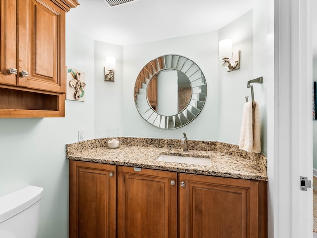 bathroom featuring vanity and toilet