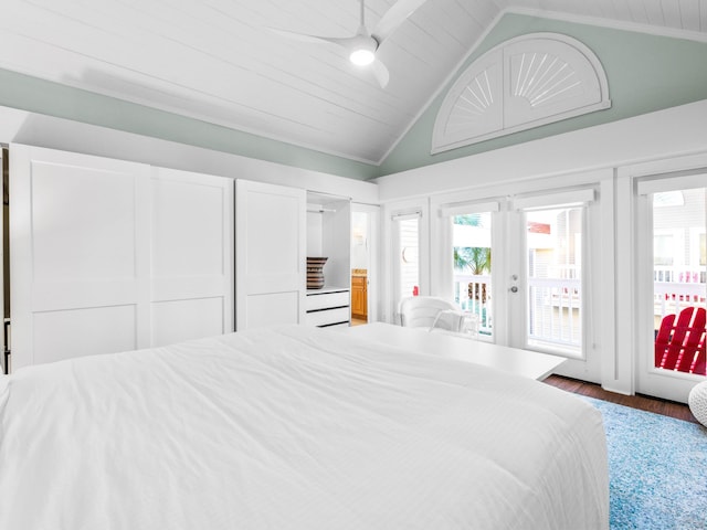 bedroom featuring wood-type flooring, lofted ceiling, access to outside, ceiling fan, and french doors