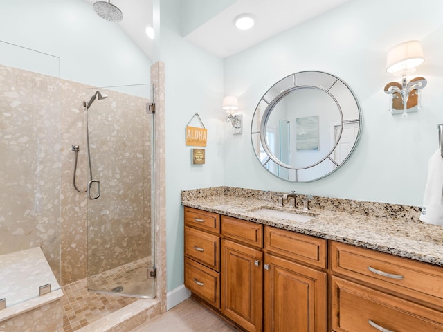 bathroom with vanity and a shower with door