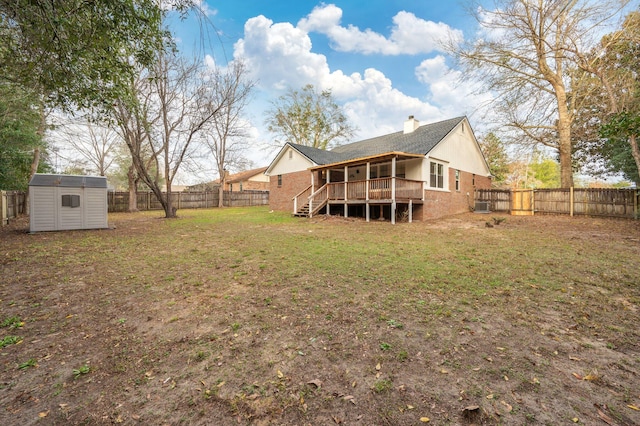 back of property featuring an outbuilding, brick siding, a storage unit, a deck, and a fenced backyard