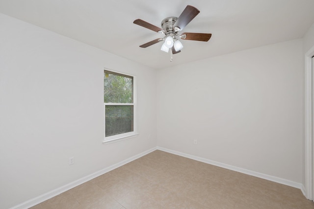 unfurnished room featuring a ceiling fan and baseboards