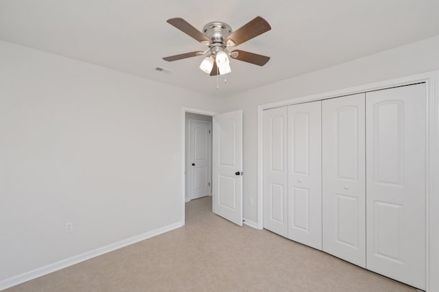 unfurnished bedroom featuring a ceiling fan, baseboards, visible vents, and a closet
